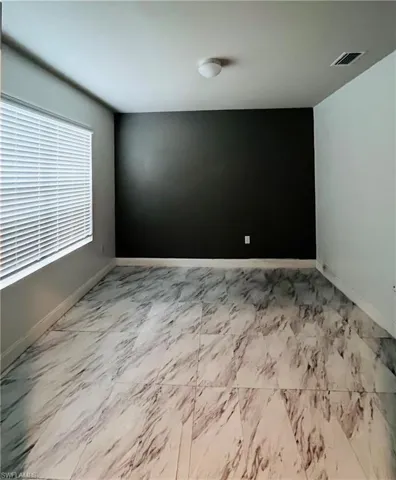 Unfurnished room featuring baseboards