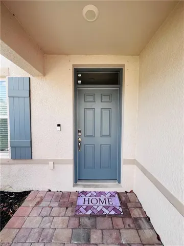 Entrance to property featuring stucco siding