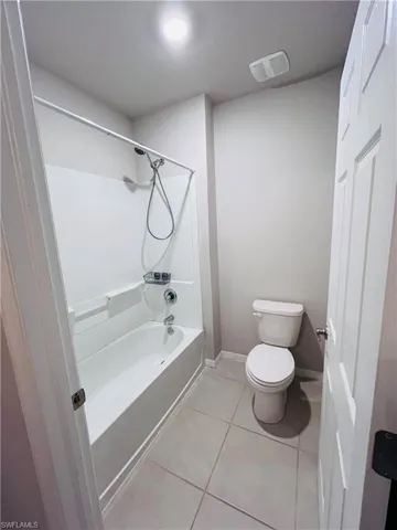Full bath featuring  shower combination and light tile patterned flooring
