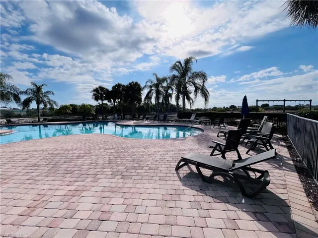 Community pool featuring a patio