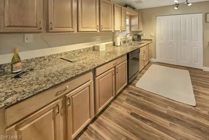 Kitchen featuring light granite countertops
