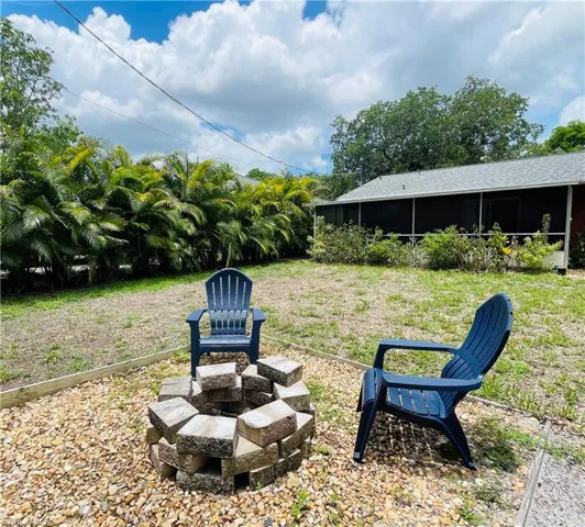 View of yard and lanai from fire pit area