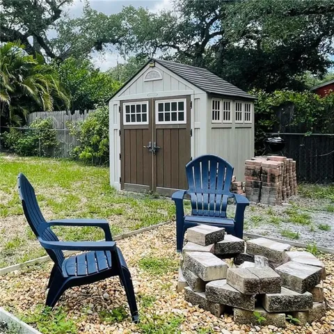 View of shed and fire pit