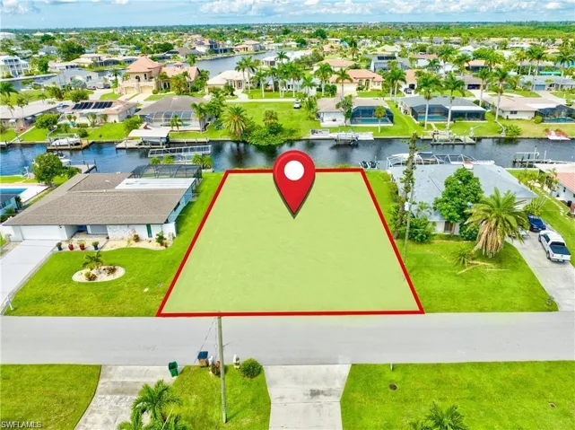 Vacant land parcel featuring canal frontage with a clear boundary outline