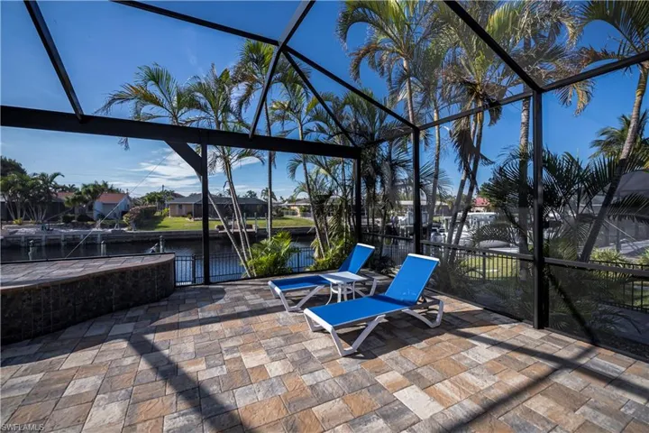 View of patio / terrace with a lanai and a water view