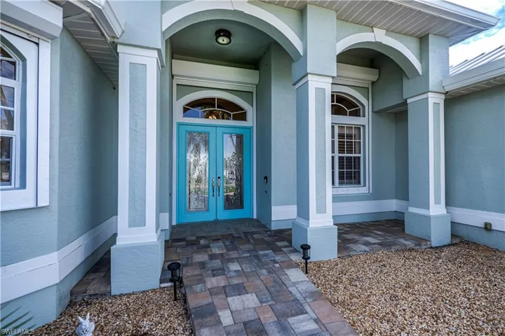 View of exterior entry featuring french doors
