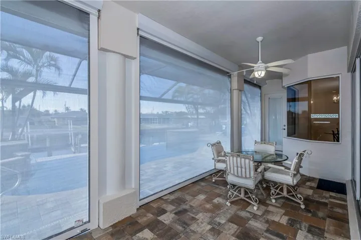 Sunroom featuring ceiling fan
