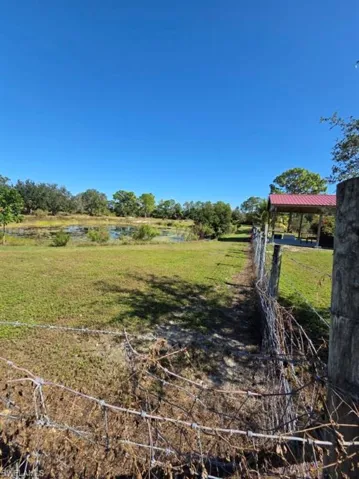 View of grassy yard with a water view