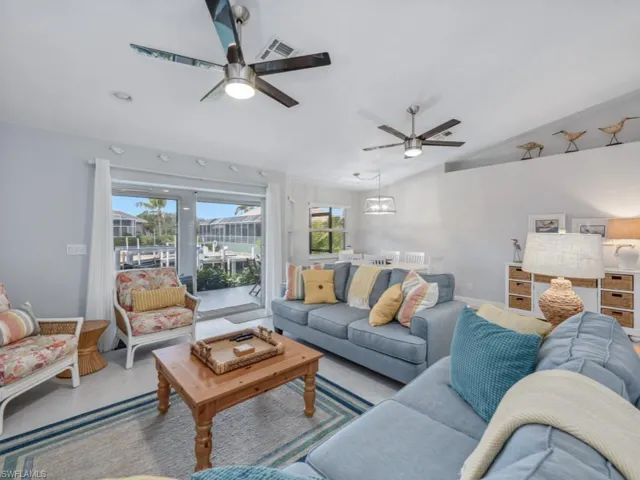 Living room featuring a ceiling fan and lofted ceiling