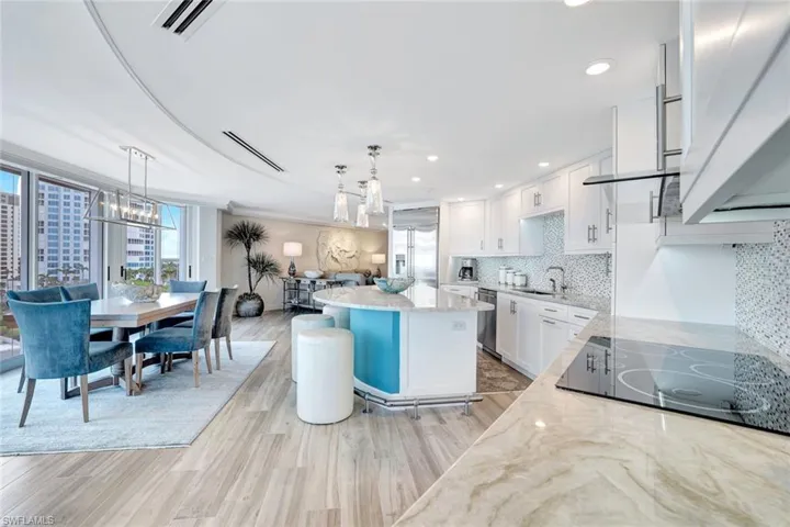 Kitchen featuring an inviting chandelier, a center island, plenty of natural light, and appliances with stainless steel finishes