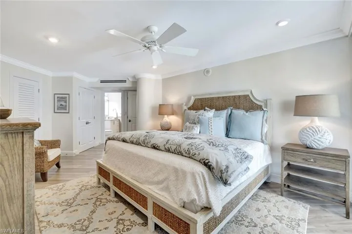 Bedroom featuring ceiling fan, ensuite bath, recessed lighting, baseboards, and ornamental molding