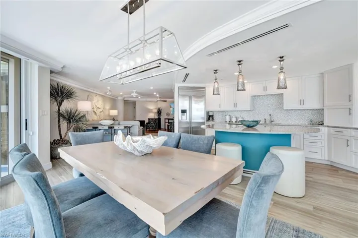 Dining room featuring ornamental molding, recessed lighting, and light wood-style flooring