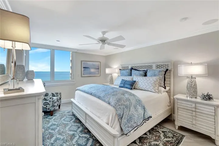 Bedroom with crown molding, ceiling fan, and baseboards