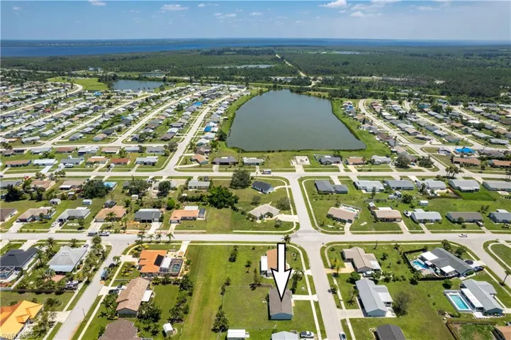 Birds eye view of property with a residential view and a water view