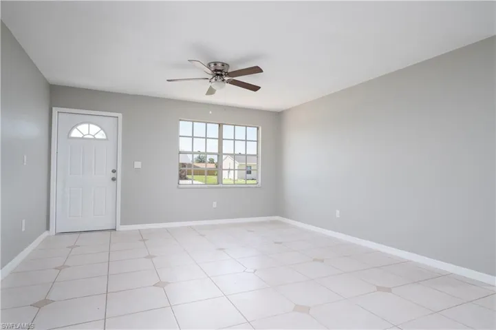 Entryway with ceiling fan and baseboards