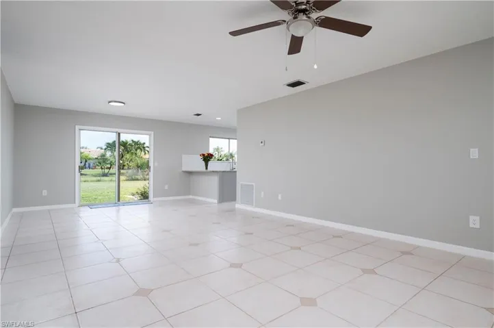 Spare room featuring baseboards, visible vents, and light tile patterned flooring