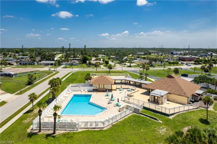 Pool with a residential view, fence, and a patio