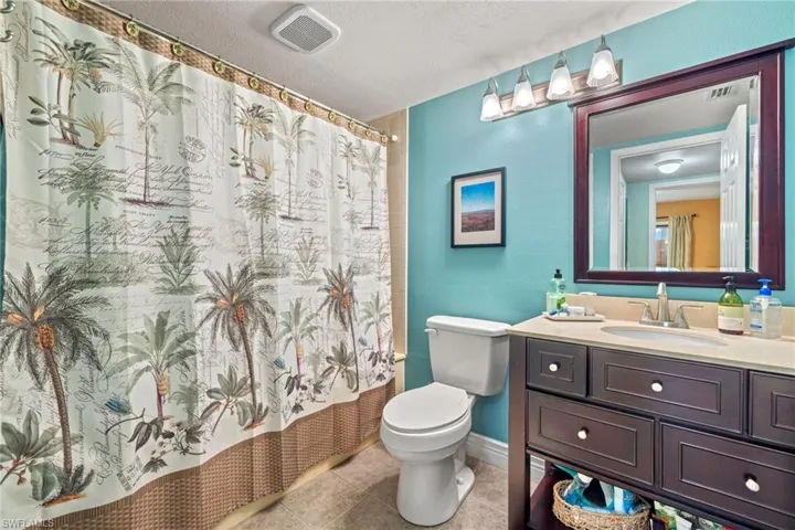The downstairs bathroom featuring vanity, tile flooring and a very large garden tub/shower combo.