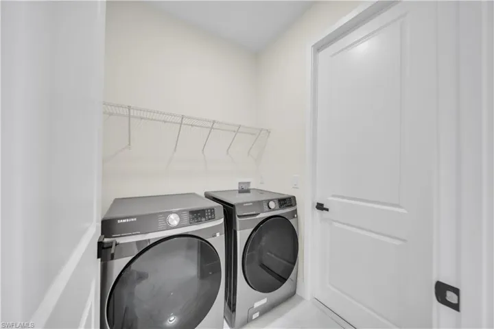 Laundry area featuring washing machine and clothes dryer