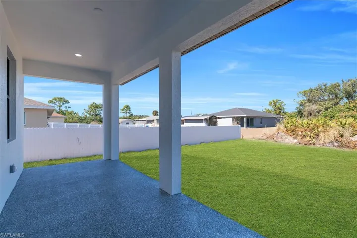 Fenced backyard with a patio