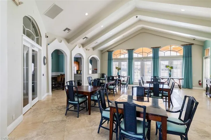 Dining area with french doors, arched walkways, recessed lighting, and a high ceiling