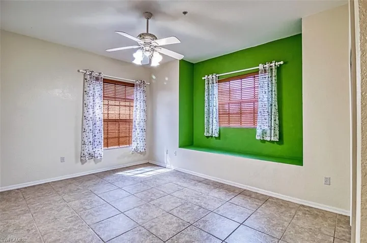 Unfurnished room featuring ceiling fan and light tile patterned floors