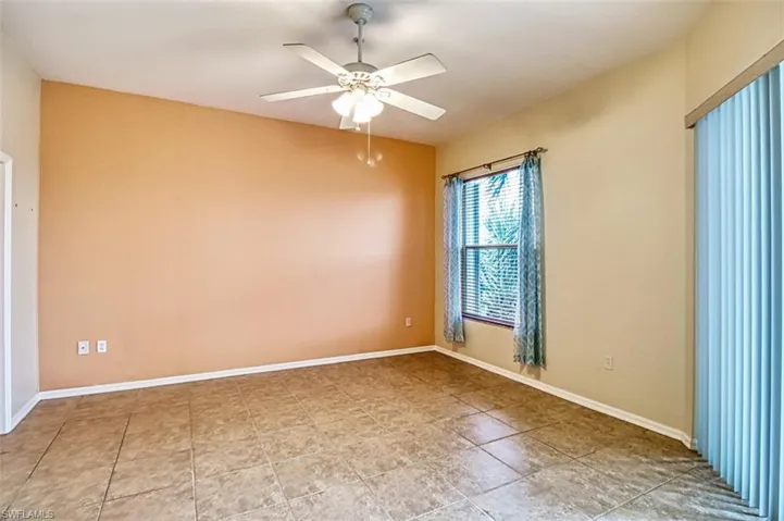 Spare room with a ceiling fan and baseboards