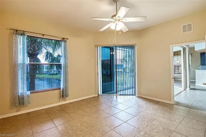 Empty room featuring a ceiling fan and light tile patterned flooring