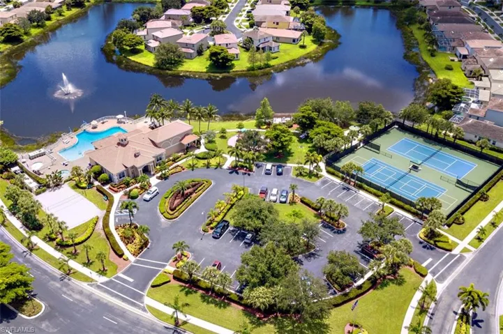 Aerial perspective of suburban area with a nearby body of water and a pool
