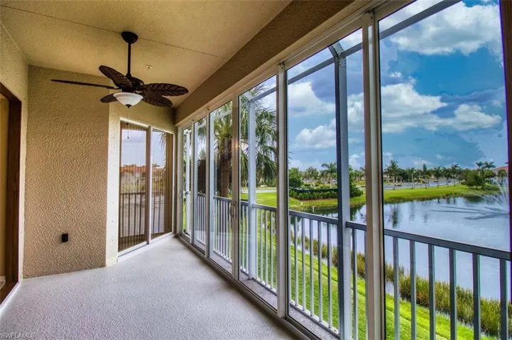 Unfurnished sunroom featuring a textured wall and a water view