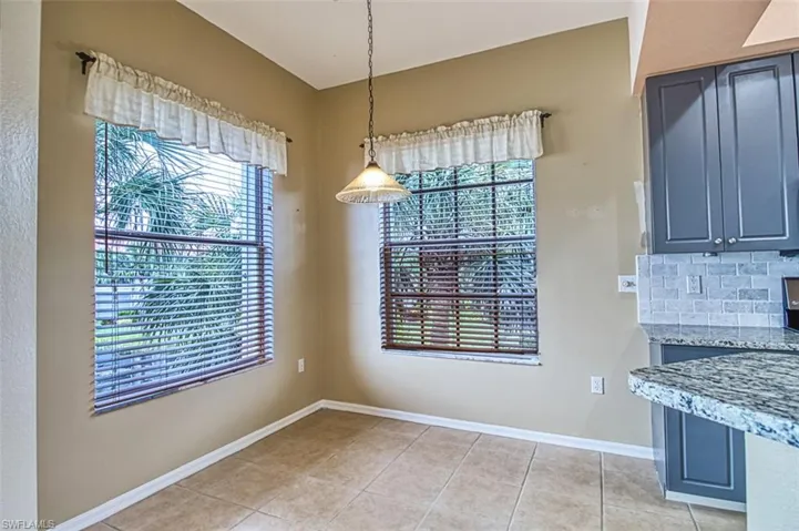 Unfurnished dining area featuring baseboards and light tile patterned floors