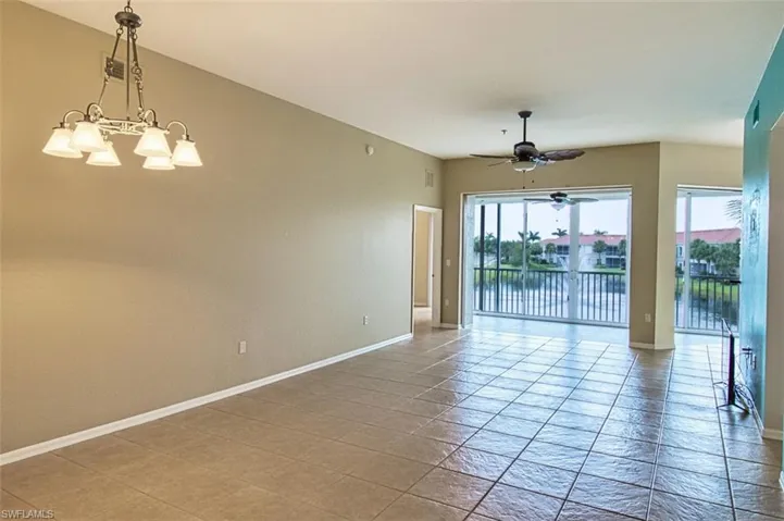 Spare room with suspended lighting and a ceiling fan
