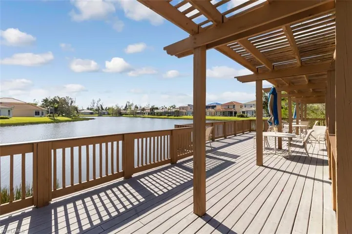 Deck featuring a residential view, a water view, and a pergola