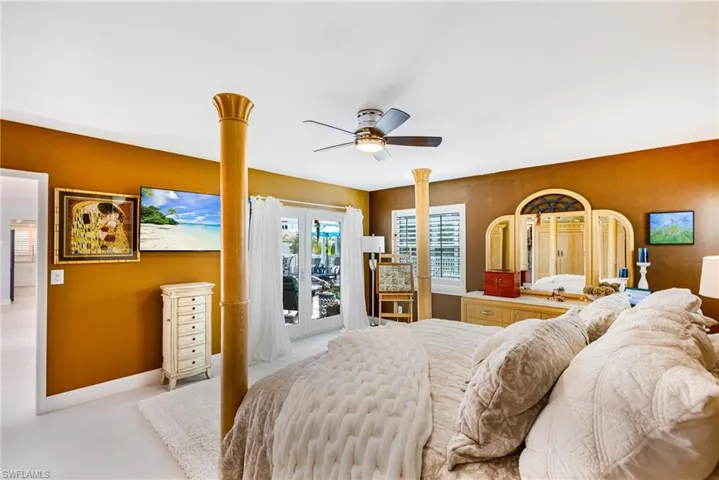 Bedroom featuring access to outside and a ceiling fan
