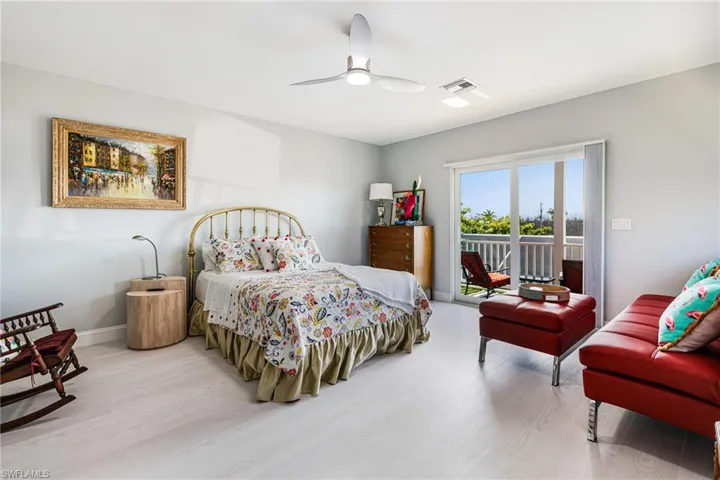 Bedroom with access to outside, light wood-style flooring, and a ceiling fan