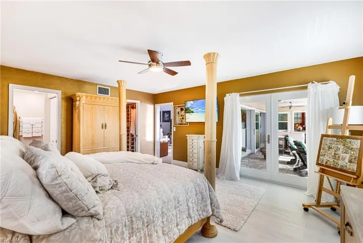 Bedroom with access to exterior, light wood-style floors, and a ceiling fan