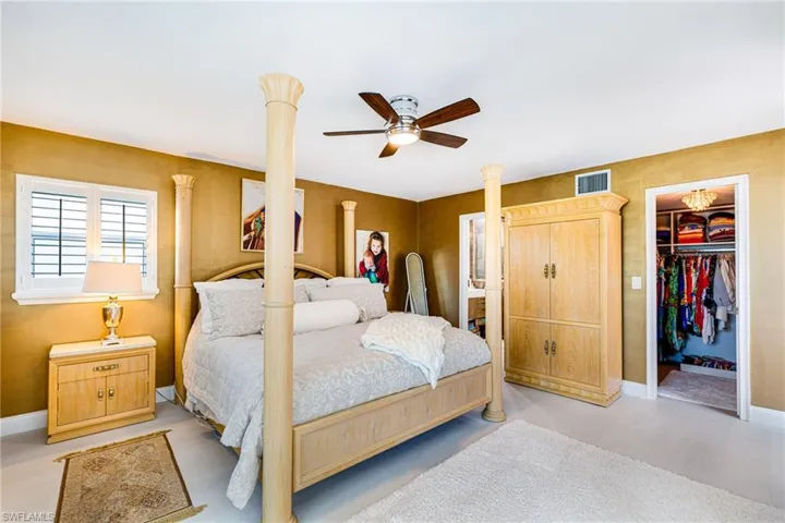 Bedroom featuring a spacious closet and ceiling fan