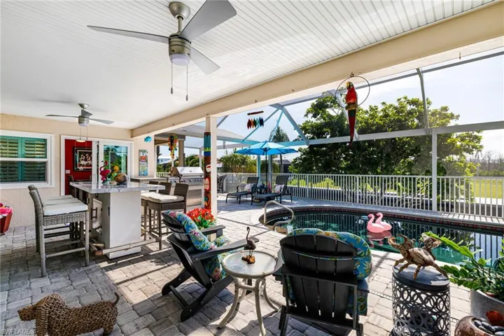 View of patio / terrace with ceiling fan and a grill