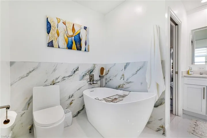 Full bathroom featuring vanity and a soaking tub