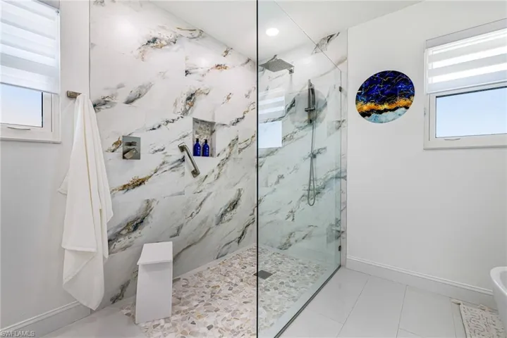 Bathroom featuring a marble finish shower