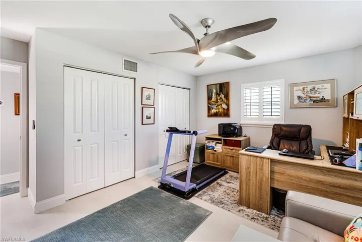 Office space featuring a ceiling fan and baseboards