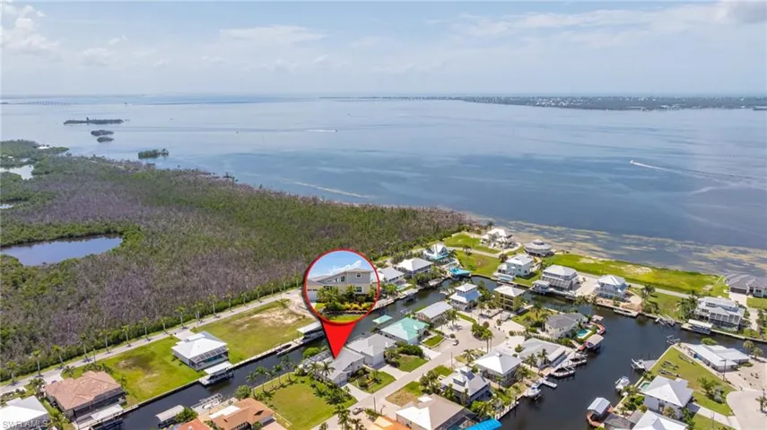 Aerial view of residential area featuring a large body of water