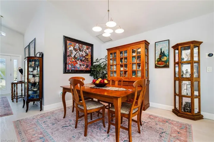 Dining room with vaulted ceiling and a chandelier