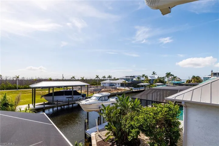 Dock area featuring boat lift and a water view