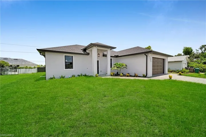 Prairie-style house with a garage and a front lawn
