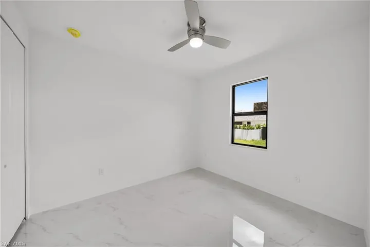 Spare room with ceiling fan