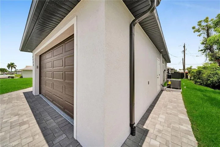 View of side of property featuring a yard