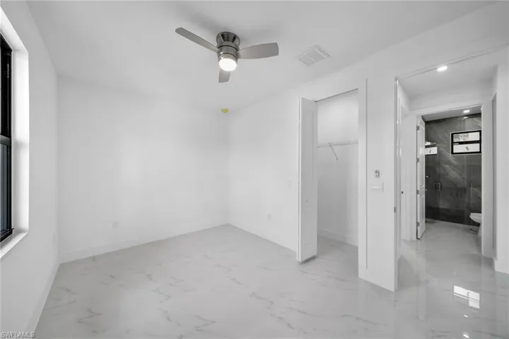 Unfurnished bedroom featuring light tile patterned flooring, a closet, and ceiling fan