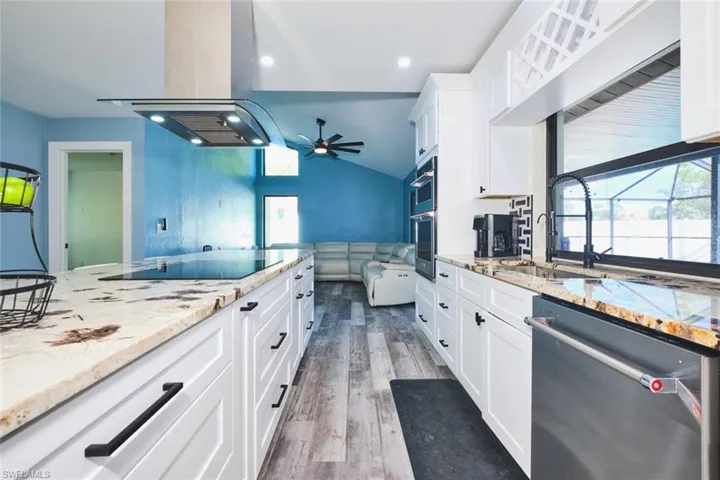 Kitchen from another angle.  Plenty of cabinetry.  Can't hear any noise from outside with these impact windows.  Everything you see was installed in 2025!