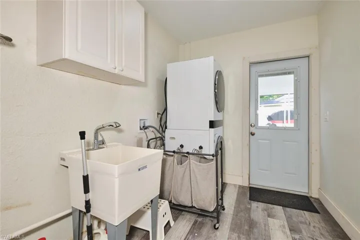 Wash tub, stackable washer and dryer.  Outside impact rear door is the entry to the in-kaw/apartment.
